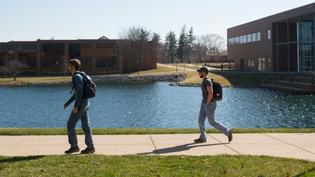 Students walking down the sidewalk outside of chapel